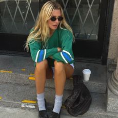 Creator @meganadelaide sitting outside on a step