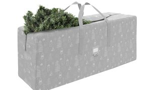 A light gray Christmas tree storage bag with white tree designs on it, for the best Christmas tree storage bags.