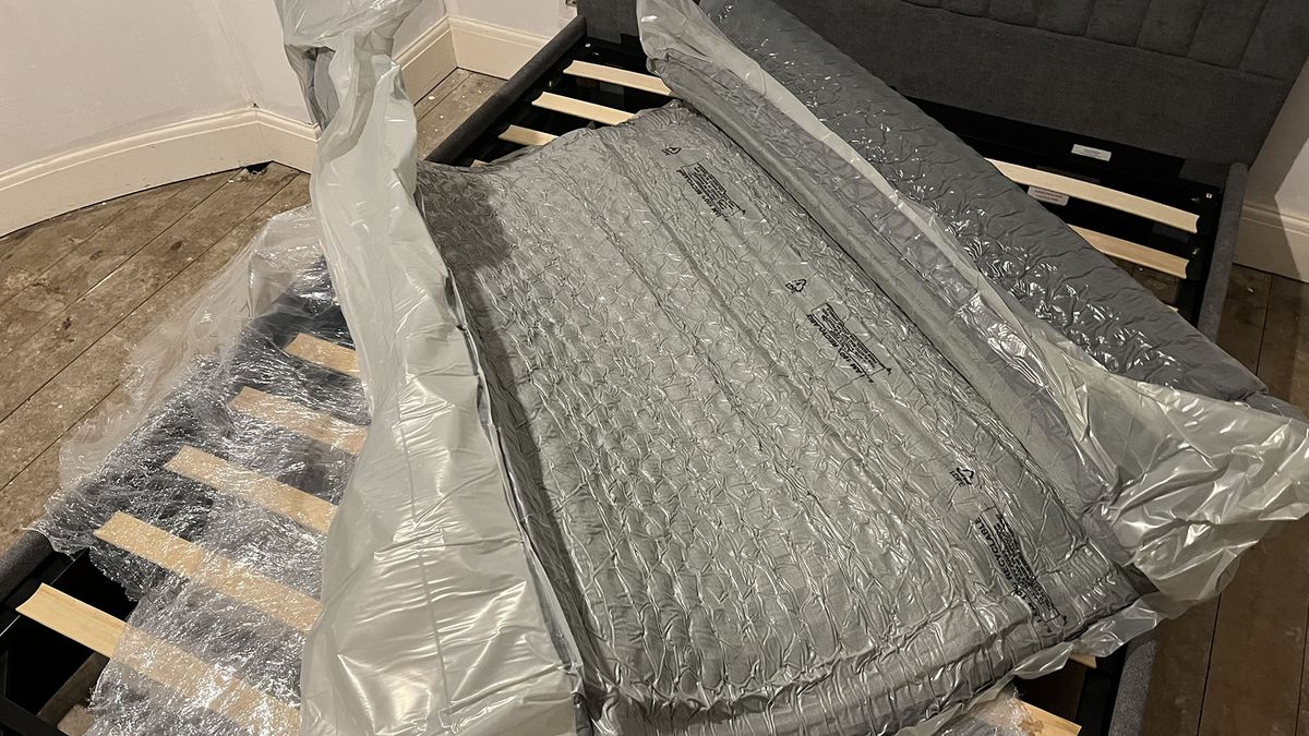 Zoma Hybrid mattressZoma Hybrid mattress vacuum-packed and unravelling on reviewer's bed frame