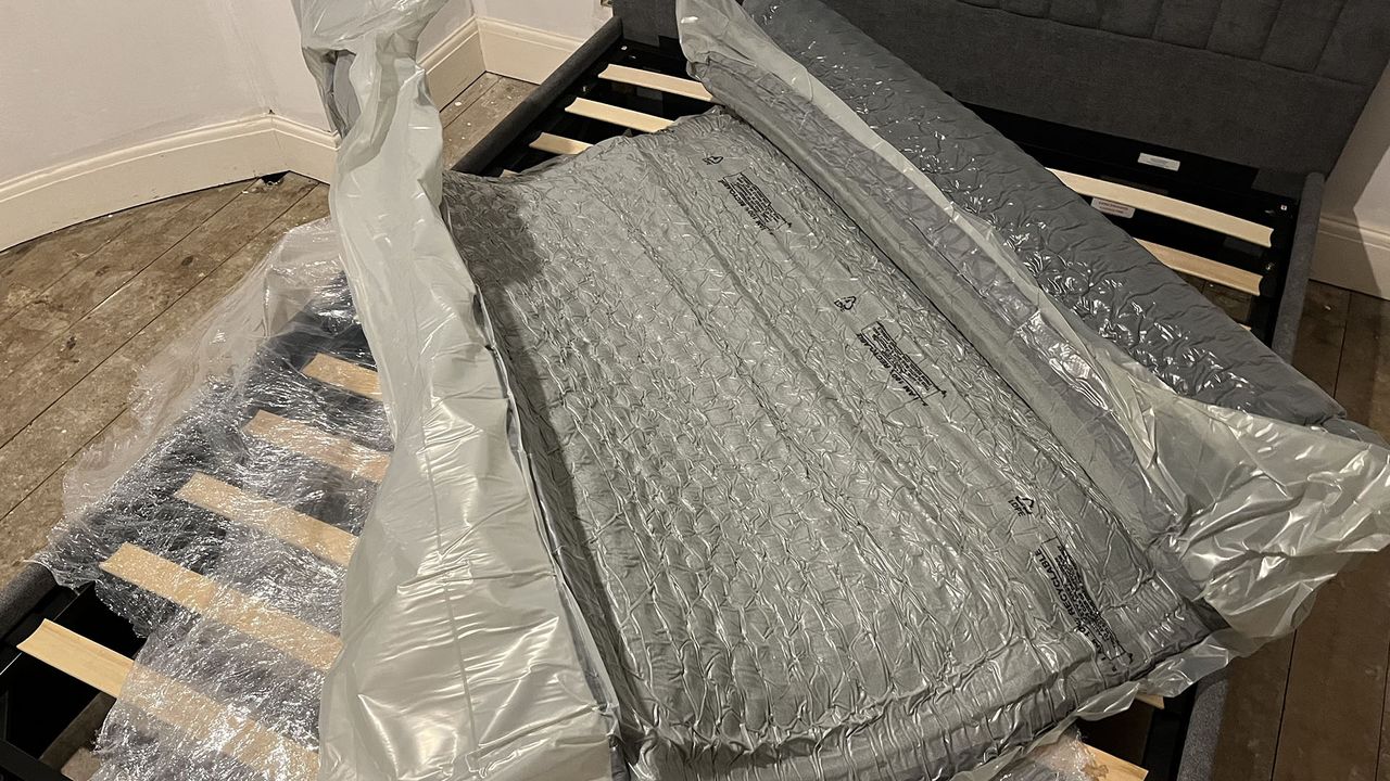 Zoma Hybrid mattressZoma Hybrid mattress vacuum-packed and unravelling on reviewer's bed frame