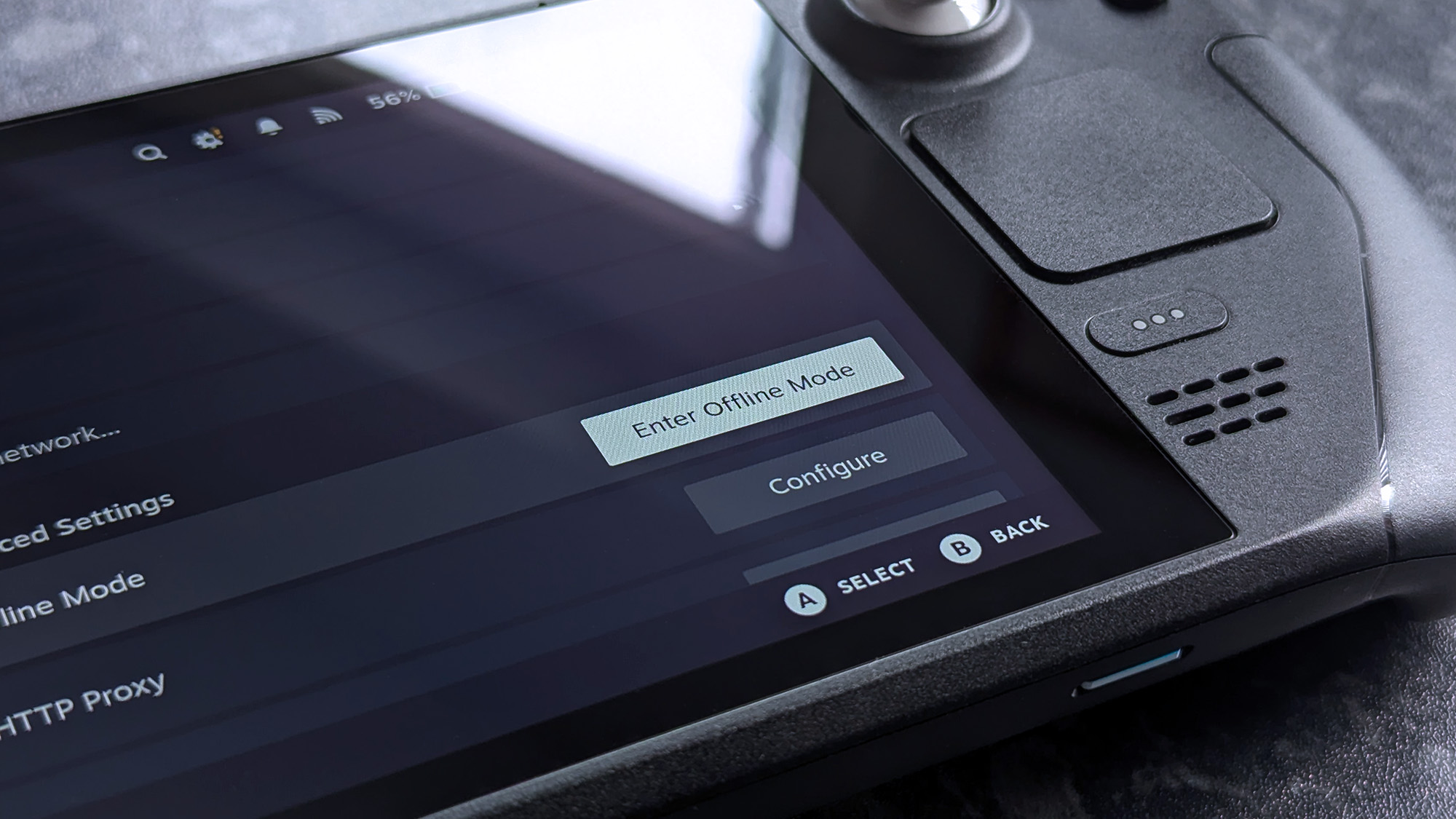 A close-up of a Steam Deck handheld console showing its network settings screen, with Offline Mode visible on the display.