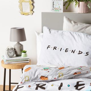 friends bedding with white wall and table lamp