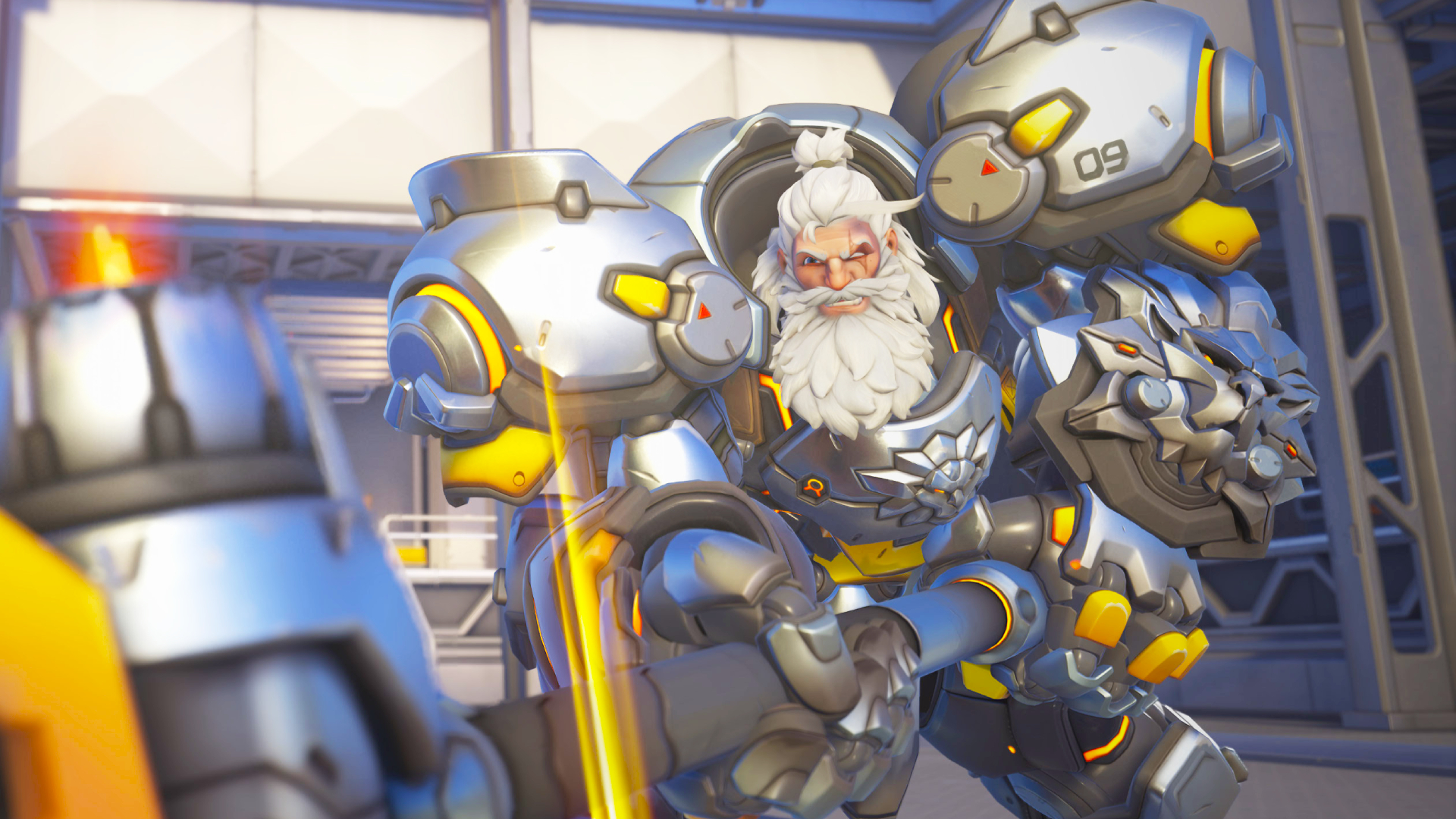 A screenshot of Overwatch hero Reinhardt. A massive character with bulky metallic armor slams his giant hammer down while facing the viewer.