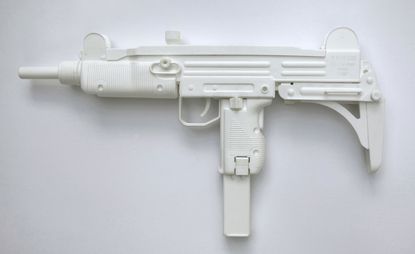 A white model of an uzi machine gun, captured against a white background