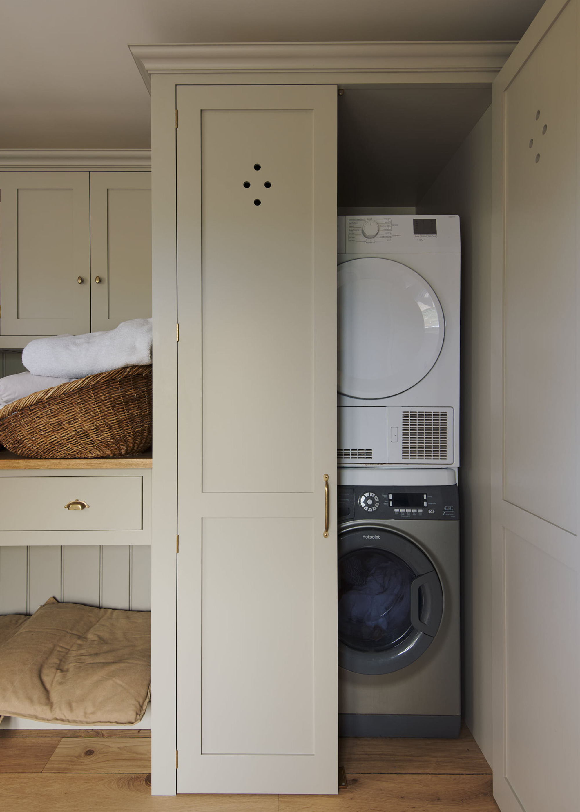 washing machine and tumble dryer in a wooden cupboard in a utility room