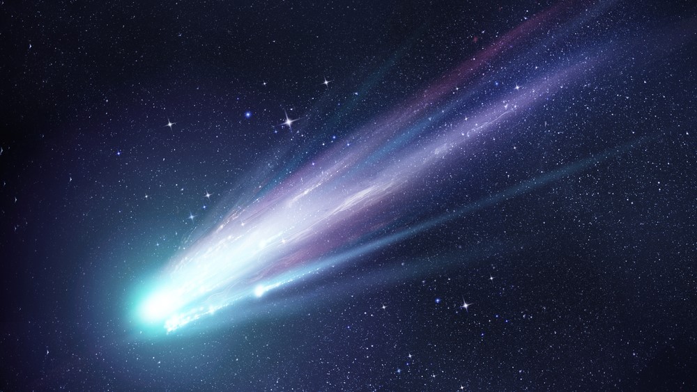 An artist's impression of a comet flying through space trailed by twin streams of gas and dust.