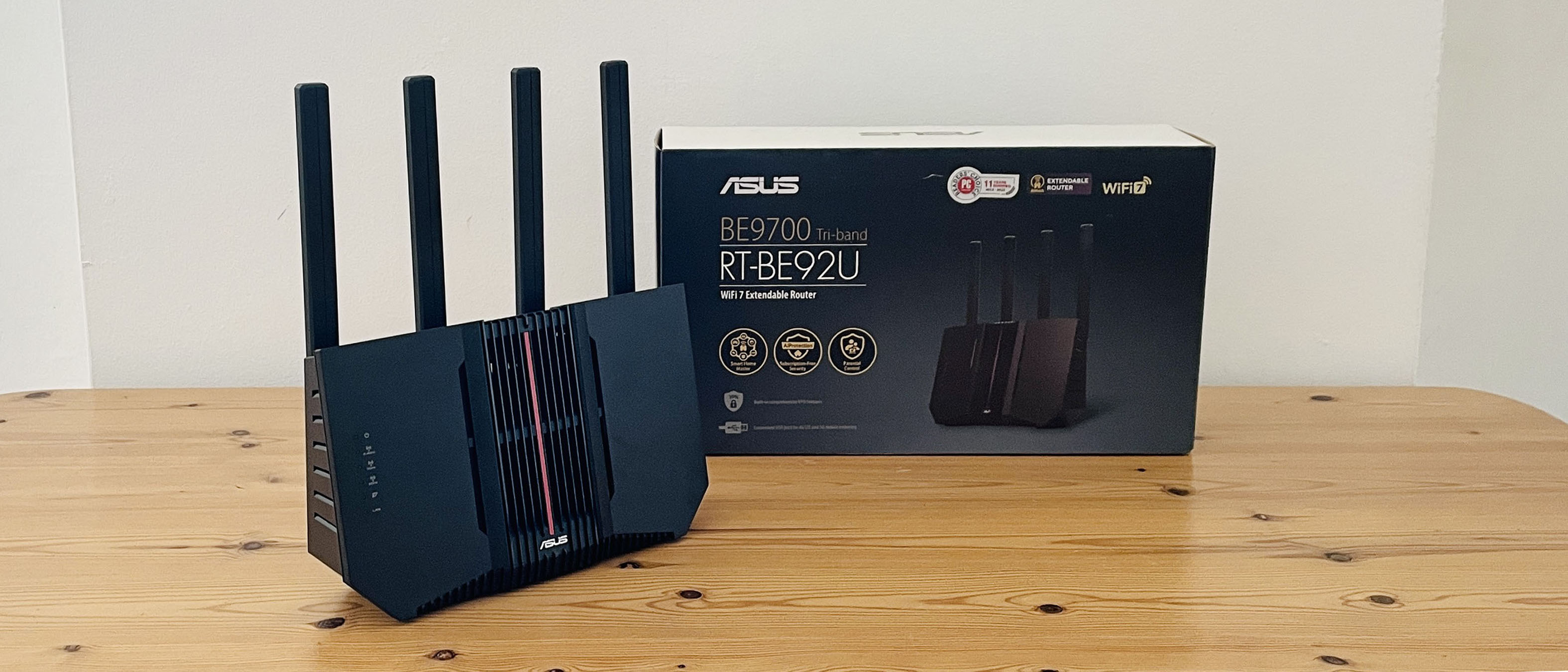 Asus RT-BE92U router on wooden table with box