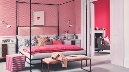 Red themed room with blck four poster bed and red patterned wall paper