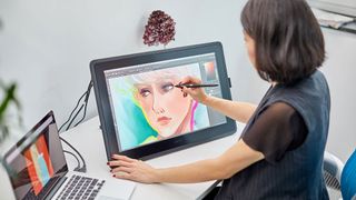 Woman using Wacom Cintiq 22 drawing tablet for digital art