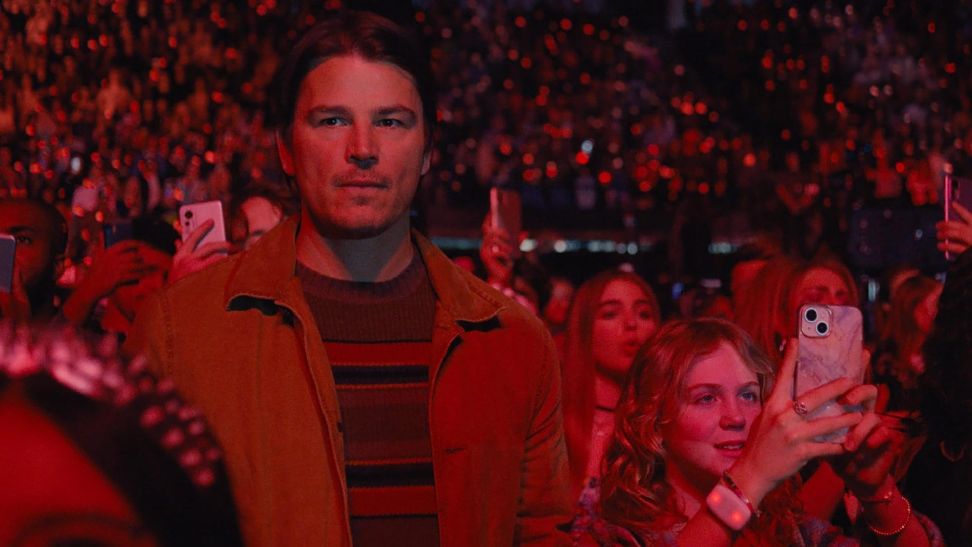 Josh Hartnett stands in a crowd during a concert in Trap