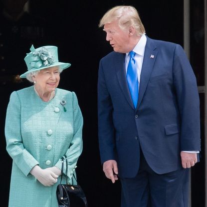 Queen Elizabeth in a turquoise coat next to Donald Trump wearing a blue suit