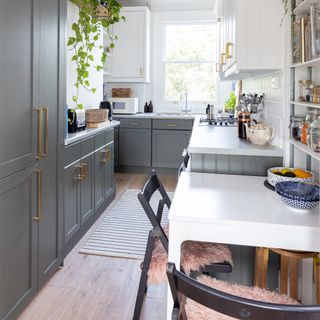 Double galley kitchen with small table