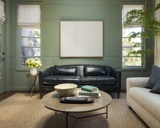 library with green paneling, sisal rug, indigo leather sofa and white sofa