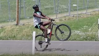 A man doing a wheelie on a bike