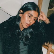 Monikh wears a black fur-trimmed jacket.
