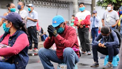 People queue for aid bonuses in Peru