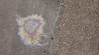 a picture of a spilt oil on conrete