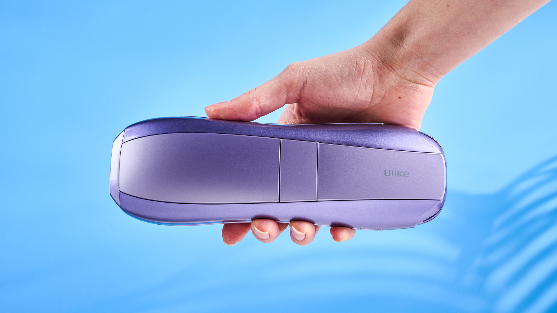 ULike Air 10 IPL machine photographed in front of a blue background.