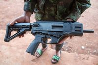 Soldier in flip flops holding 3D printed gun