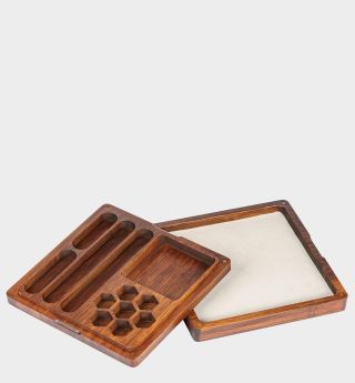 Wooden dice tray on a plain background