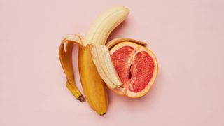 banana and grape fruit on pink background