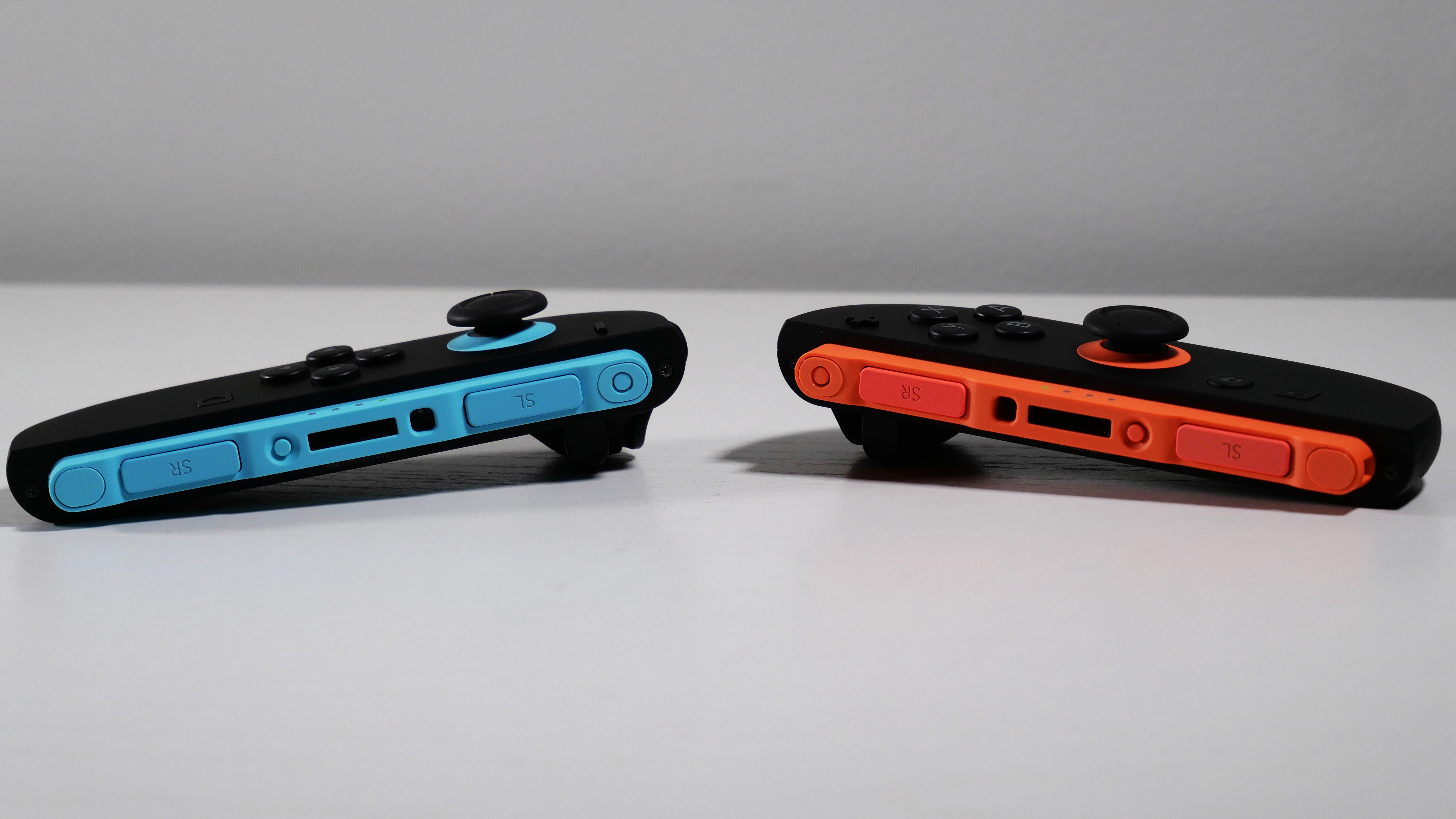 Nintendo Switch 2 Joy-Con 2 controllers laying detached a white desk.