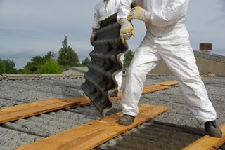 corrugated cement asbestos roof tiles being safely removed