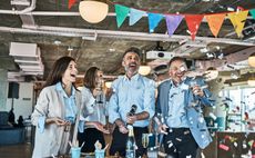 Business people celebrating with party popper in office. Group of male and female professionals celebrating in office.