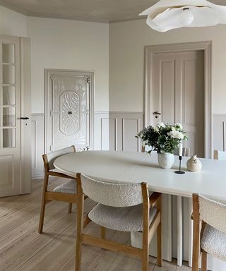 dining room with two tones of white and boucle dining chairs