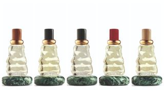 five glass Bottega Veneta perfume bottles on a white background