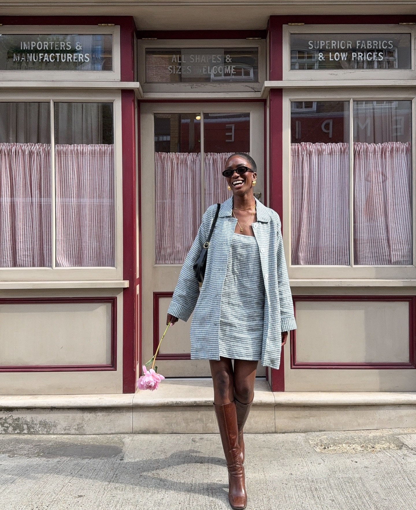 @_livmadeline wears a gingham dress and jacket set, and knee boots.