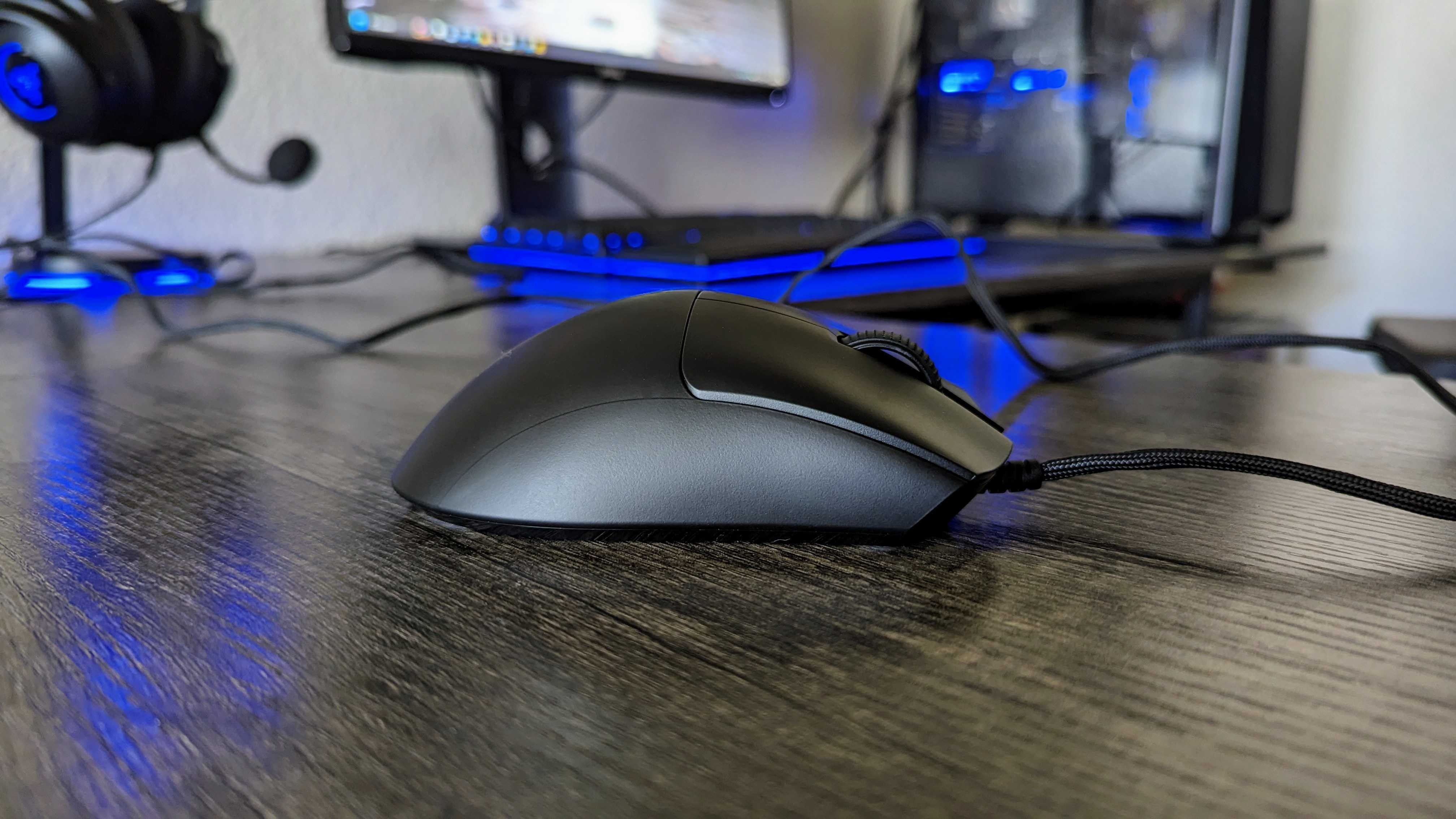 The Razer DeathAdder V3 on a desk, seen from the side.