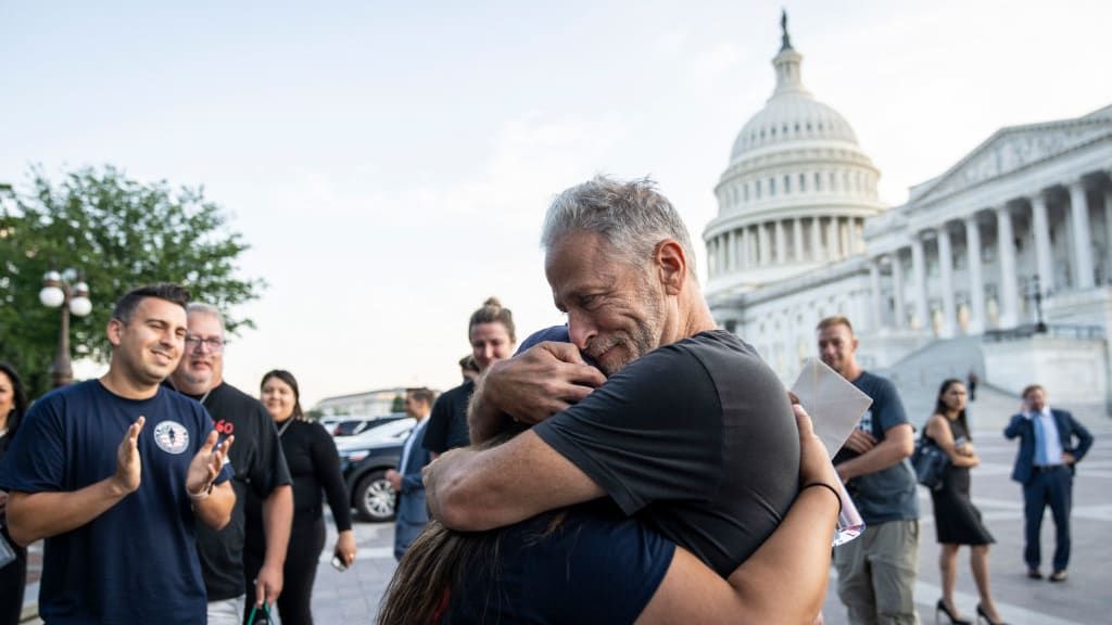 Jon Stewart hugs Rosie Torres after the 