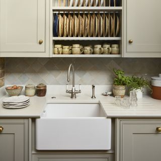 Sage green shaker kitchen with Belfast sink and plate rack
