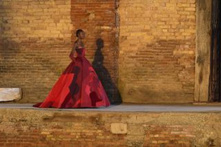 Model wears a red gown at Valentino A/W 2021 Haute Couture show