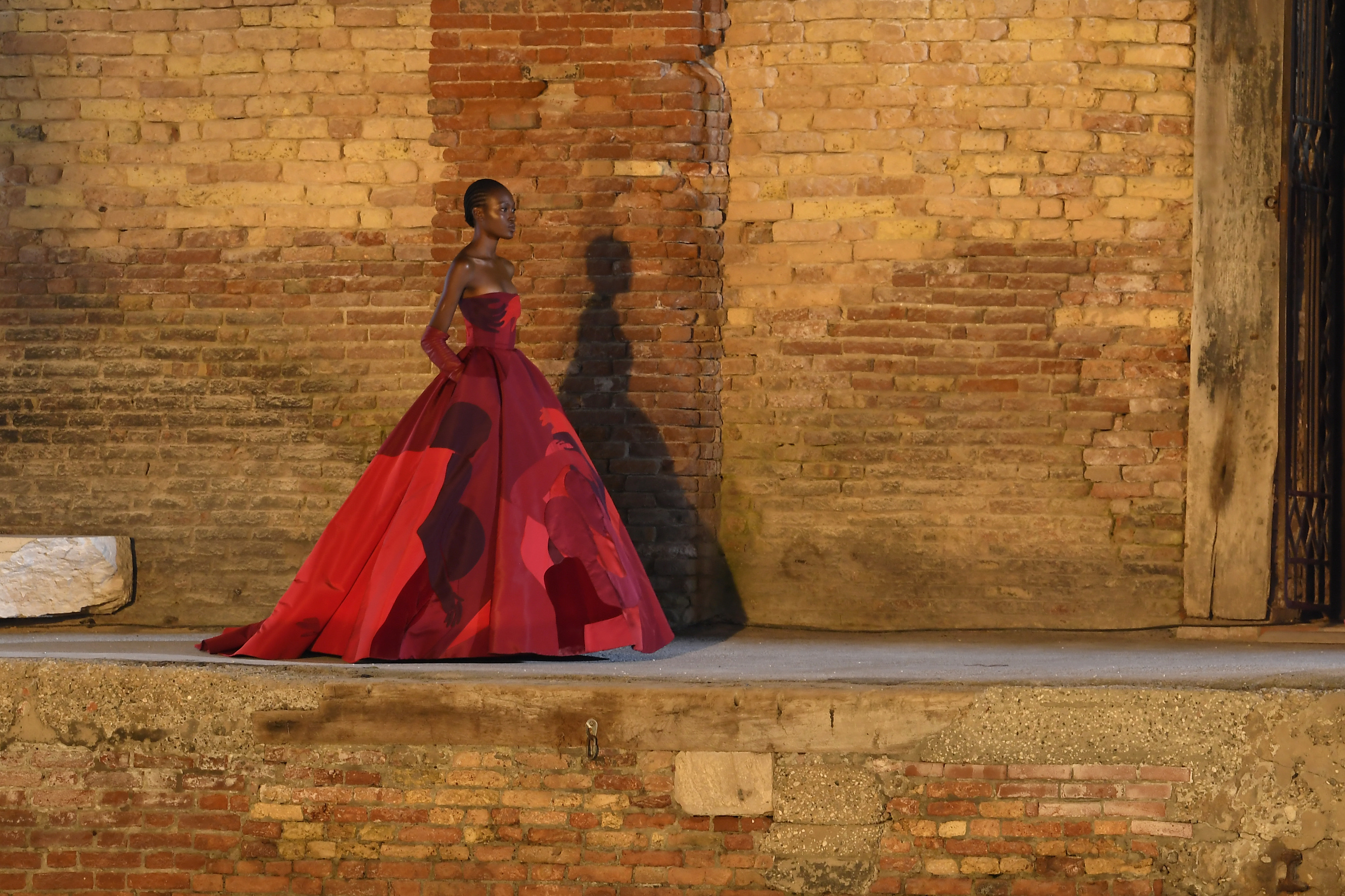 Model wears a red gown at Valentino A/W 2021 Haute Couture show