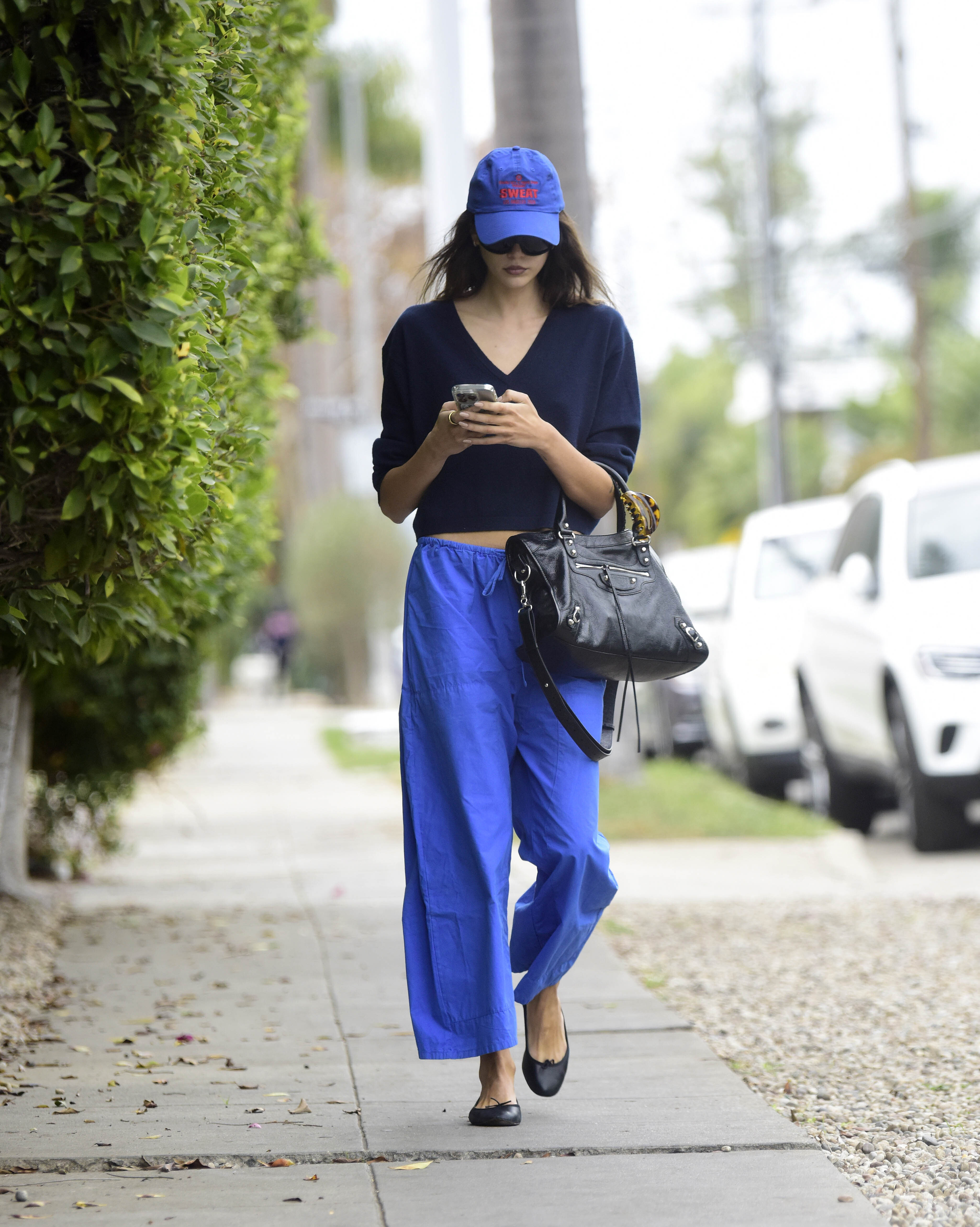 Kaia Gerber in Leset's cobalt Kyoto Carpenter Pants.