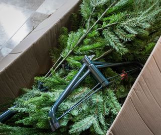 A faux christmas tree folded up into a storage box