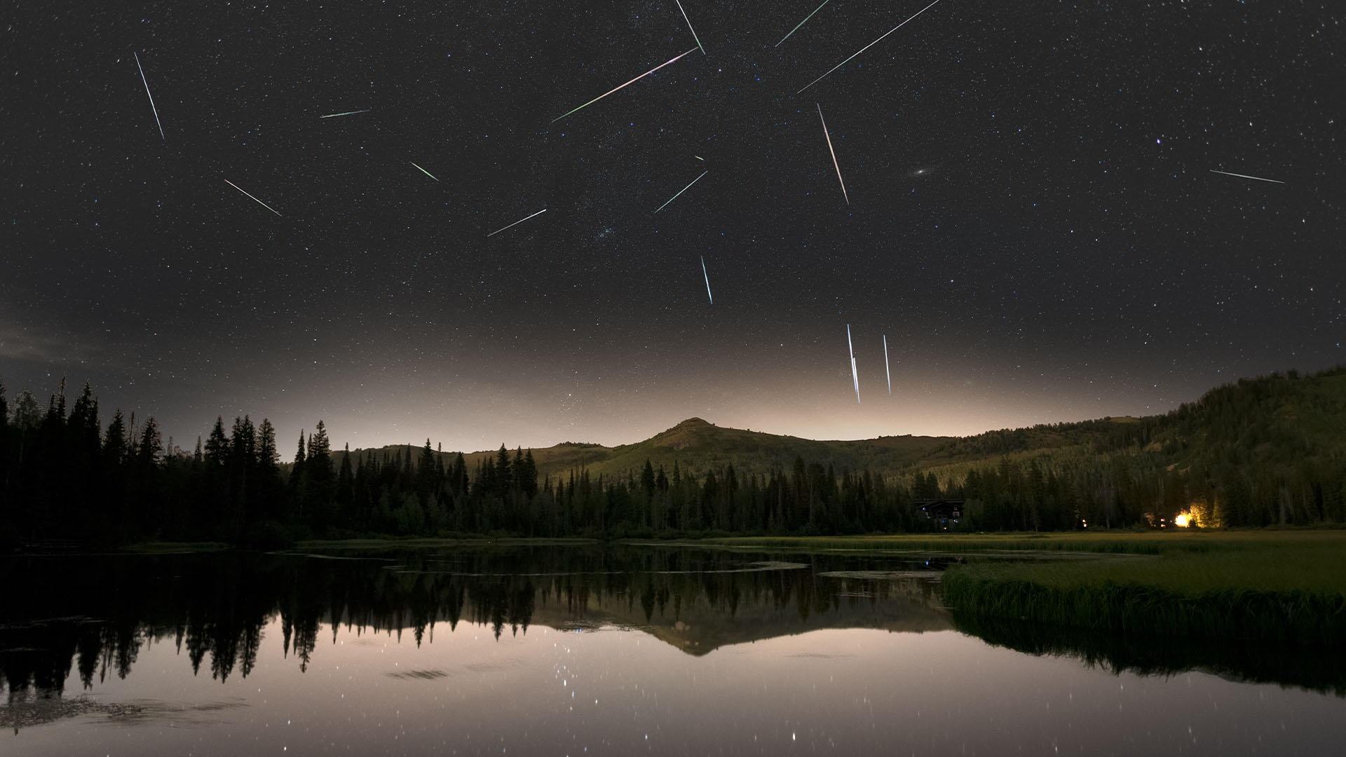 Eta Aquariid meteor shower in a scenic view of lake against sky at night, Salt Lake City, Utah, USA.