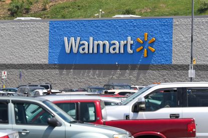 Cars fill the parking lot of the Walmart store at the Buckhorn Plaza shopping center. 