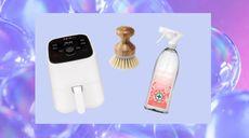 Air fryer, cleansing spray and dish brush on purple background