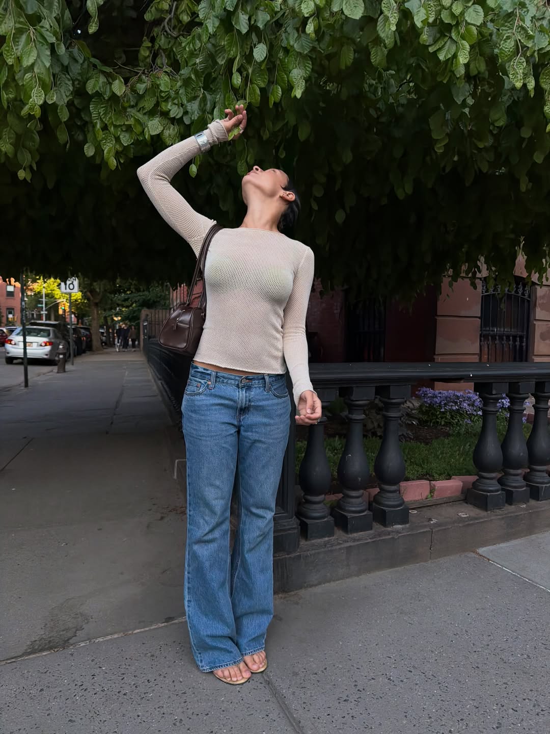 Aisha Farida wearing a low-rise bootcut jeans outfit.