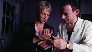 Andy Summers and Robert Fripp looking at their hands