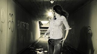 Lady walking thru dark tunnel afraid for her safety