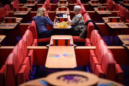 Two woman sitting at a table in a bingo hall