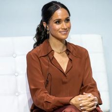 Meghan Markle wearing tan shirt with Montecito manicure on her nails