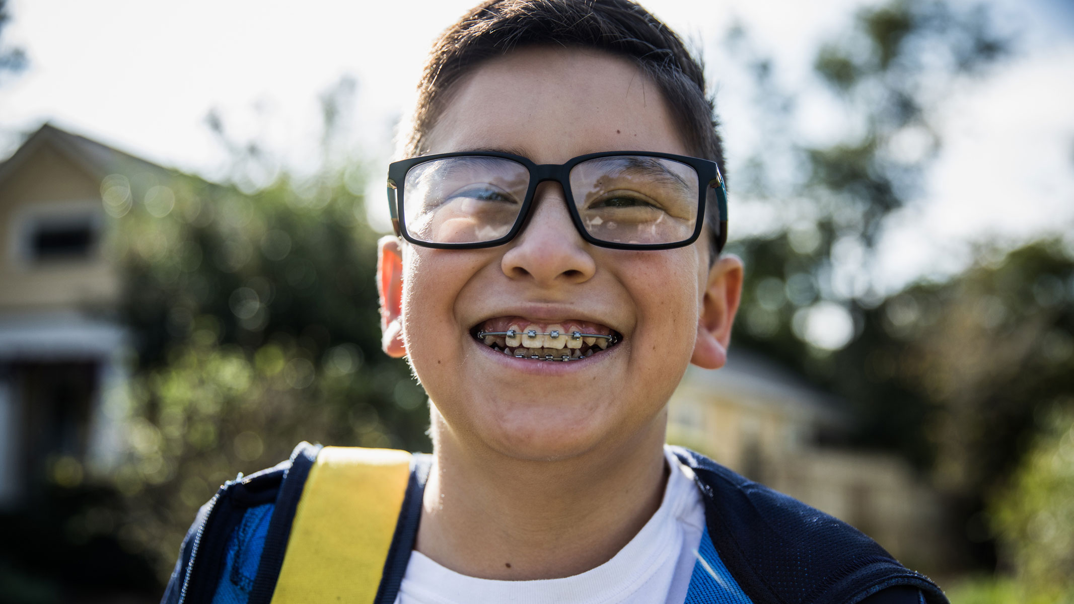 A picture of a young boy smiling and showing his braces