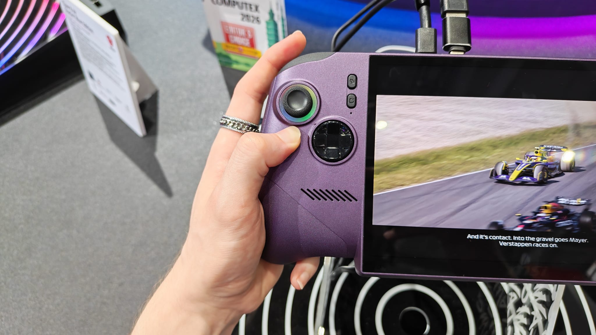 A reviewer stretching their hand to try and reach the bumpers and triggers on The MSI Claw 8 EX AI+