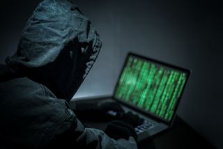 Hacker hacking on a laptop. 