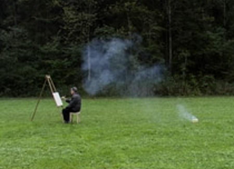 Man sat at easel in a field